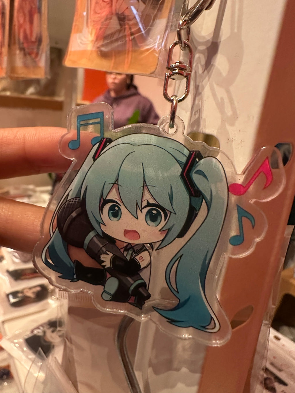 Chibi Hatsune Miku acrylic keychain detail with megaphone and musical notes