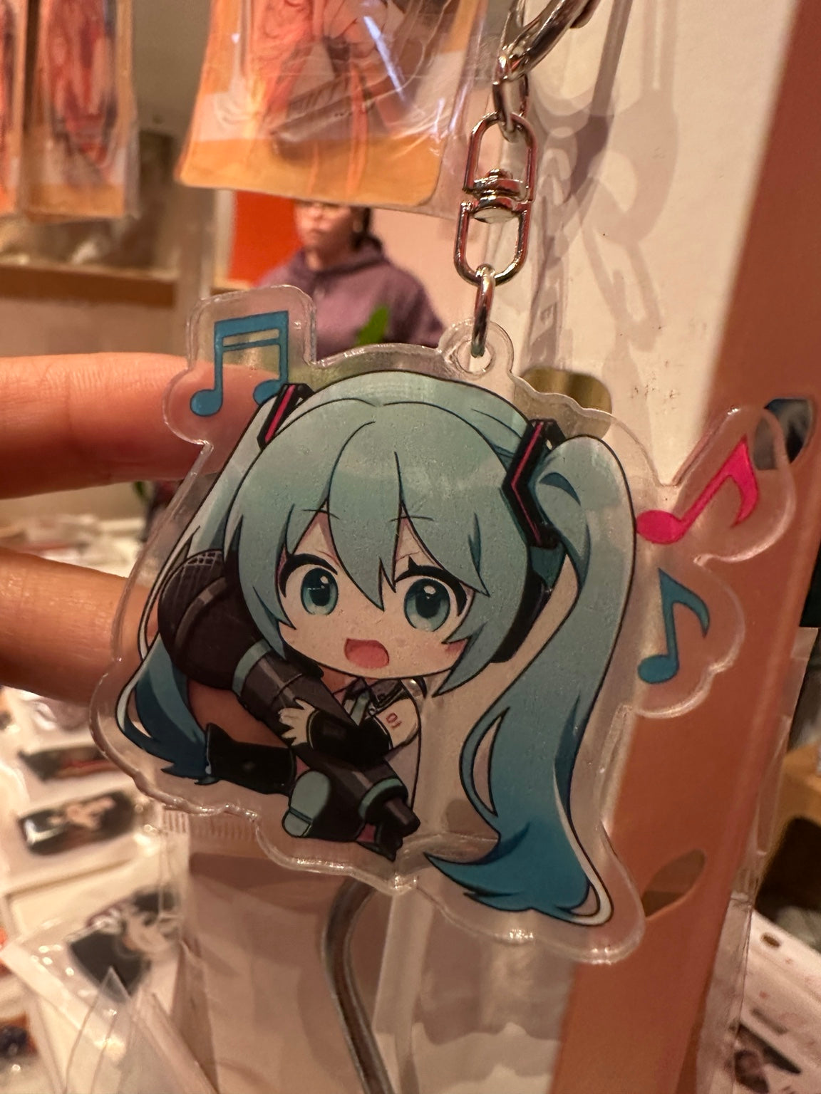Chibi Hatsune Miku acrylic keychain detail with megaphone and musical notes