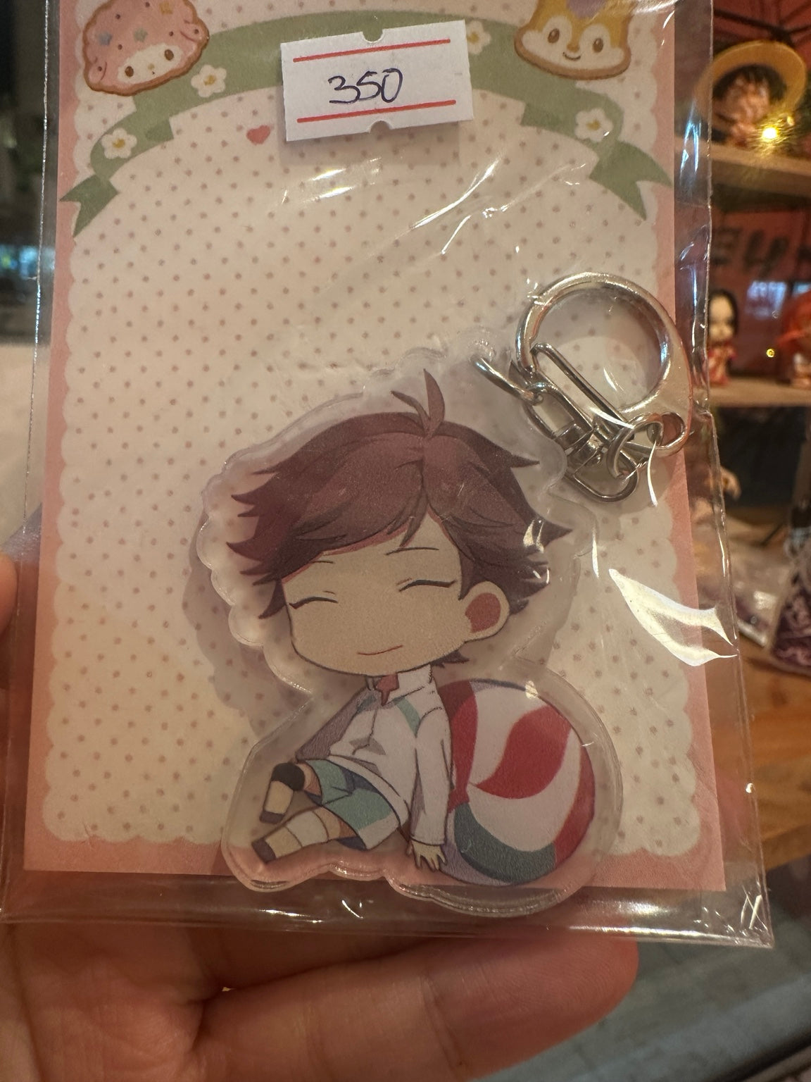 Oikawa Tooru anime keychain photographed in retail packaging