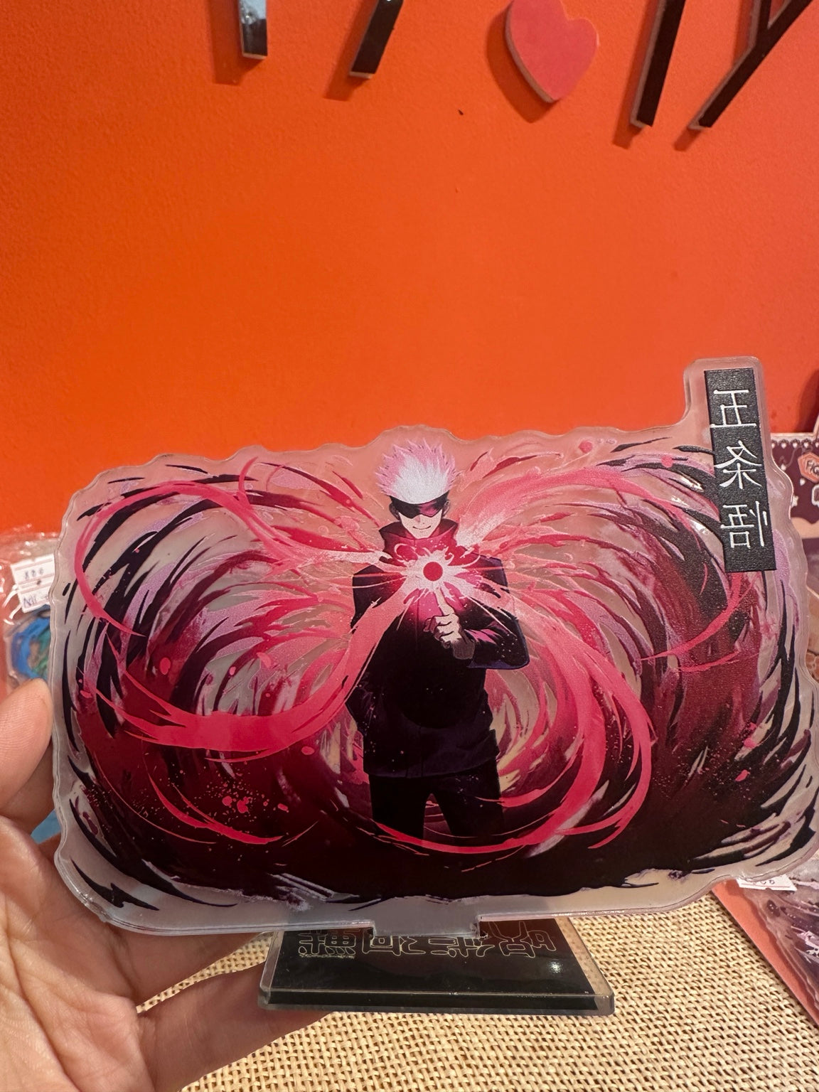 Satoru Gojo pink energy acrylic stand in display