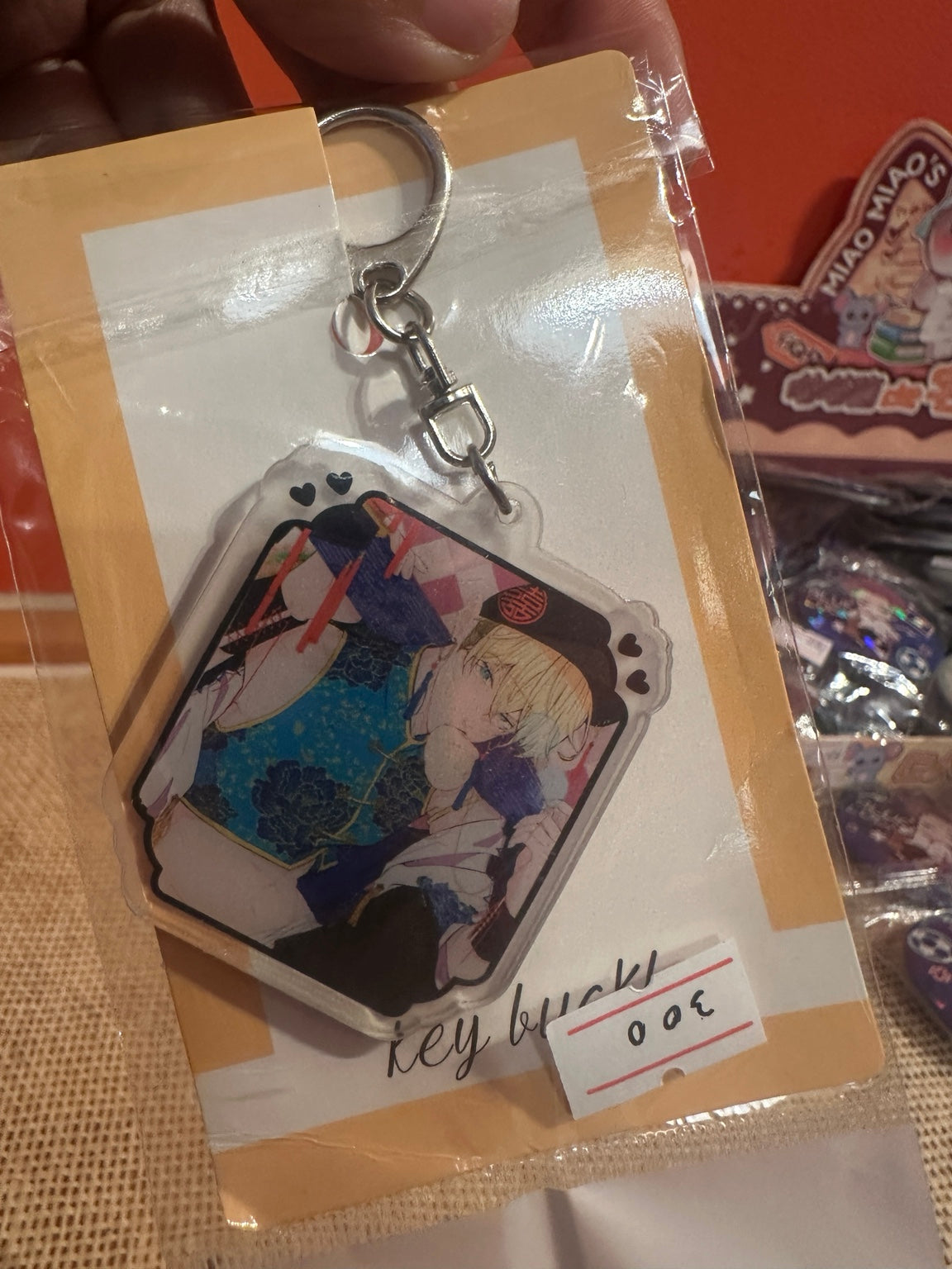 Packaged anime acrylic keychain with 300 RSD label