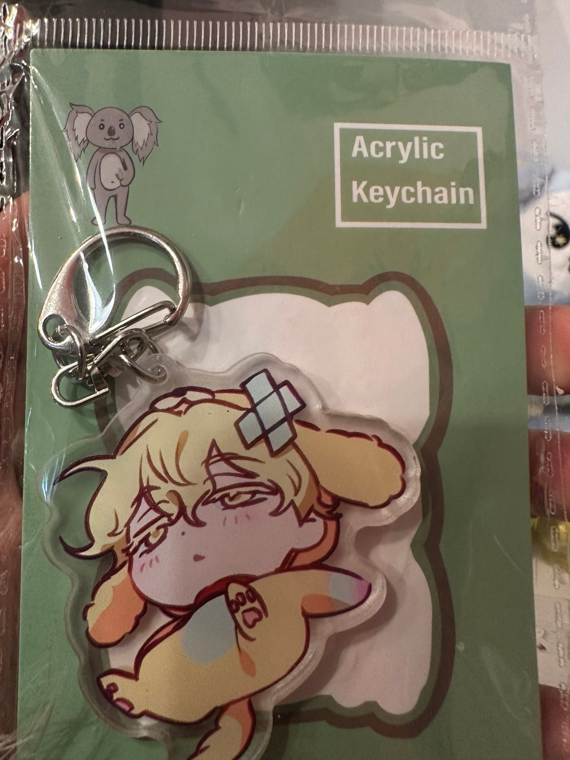 Blond anime character in yellow animal costume acrylic keychain