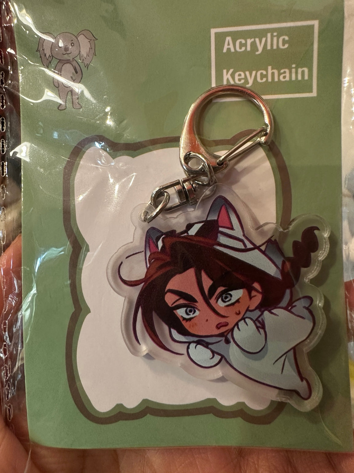 Brown-haired character wearing white fox animal costume acrylic keychain
