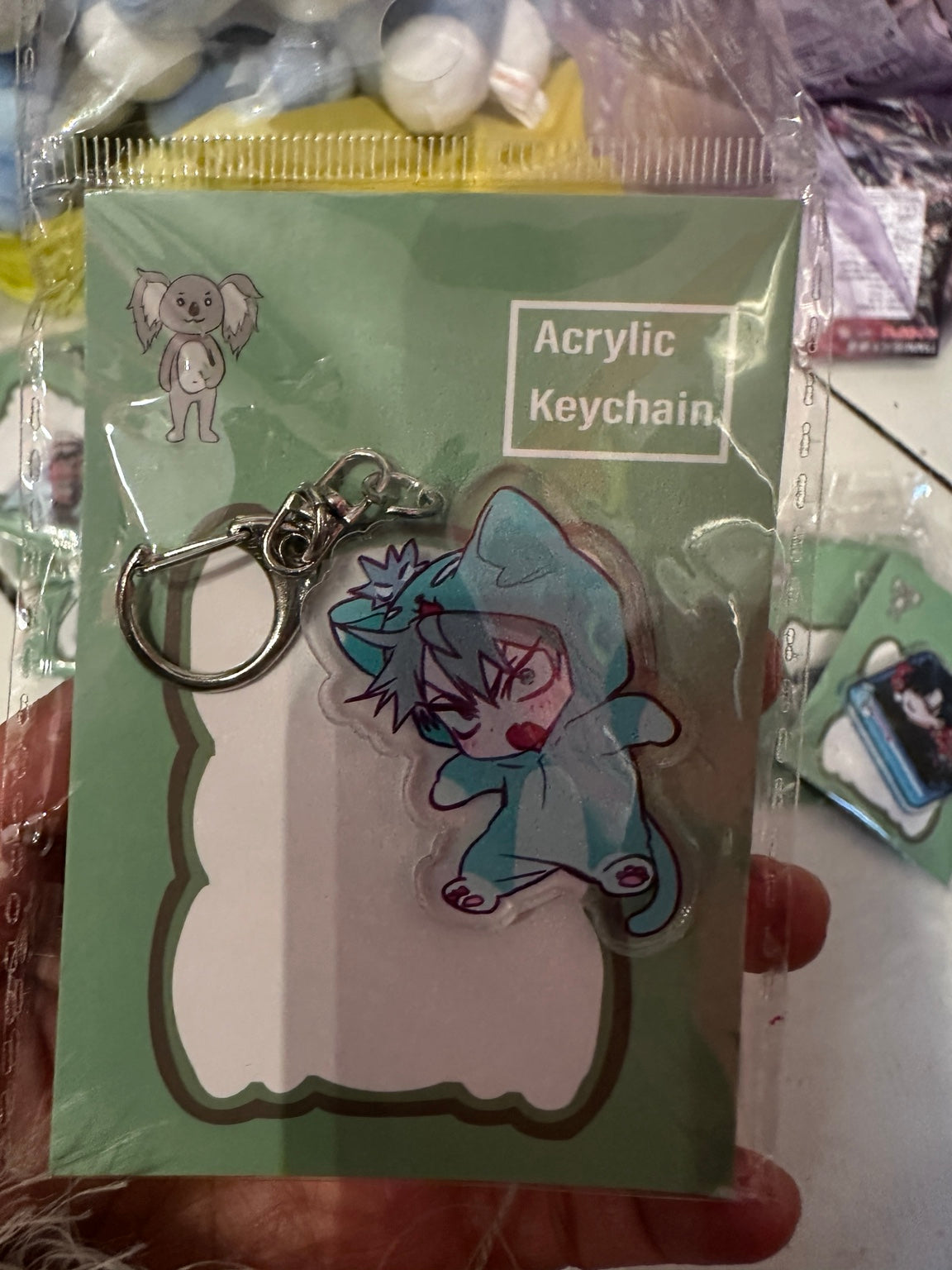 Blue-haired character in teal animal costume acrylic keychain